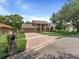 Exterior view featuring a circular driveway, attached garage, and two-story design with twin balconies, adding to its curb appeal at 871 Cynthianna Cir, Altamonte Springs, FL 32701