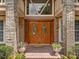 Front door entrance with a brick pathway, potted flowers, and sidelights, enhancing its inviting appearance at 871 Cynthianna Cir, Altamonte Springs, FL 32701