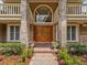 Stunning front entrance featuring double wooden doors, brick pillars, and large arched window at 871 Cynthianna Cir, Altamonte Springs, FL 32701