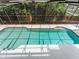 View of the pool with a screened enclosure, offering privacy and protection, under a clear sky at 871 Cynthianna Cir, Altamonte Springs, FL 32701