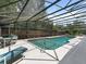 View of the pool with its screened enclosure, outdoor seating, and an adjacent manicured garden at 871 Cynthianna Cir, Altamonte Springs, FL 32701