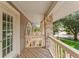 This cozy porch features wood floors, a wood railing, and stunning neighborhood views at 871 Cynthianna Cir, Altamonte Springs, FL 32701