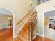 Elegant staircase featuring wood steps, iron railings, and hardwood floors at 871 Cynthianna Cir, Altamonte Springs, FL 32701