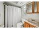 This bathroom features a shower with a white curtain, vanity with sink, and a mirrored medicine cabinet at 101 Ludlow Dr, Longwood, FL 32779