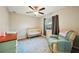 Cozy bedroom with a ceiling fan, crib, rocking chair, and natural light from the window at 101 Ludlow Dr, Longwood, FL 32779