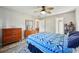 Bedroom with a ceiling fan, dresser, and a view to the dining area and en-suite bathroom at 101 Ludlow Dr, Longwood, FL 32779