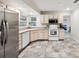 Well-lit kitchen featuring stainless steel refrigerator and ample counter space at 101 Ludlow Dr, Longwood, FL 32779