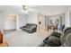 Open-concept living and dining area with neutral walls, and plush carpeting throughout the living area at 101 Ludlow Dr, Longwood, FL 32779