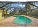 The screen-enclosed backyard pool features brick pavers and mature landscaping at 101 Ludlow Dr, Longwood, FL 32779