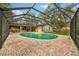 A screened-in pool sits beside the home, surrounded by brick pavers at 101 Ludlow Dr, Longwood, FL 32779