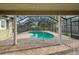 Screened-in pool area featuring a pool with a unique shape and brick deck at 101 Ludlow Dr, Longwood, FL 32779