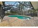 Screened-in pool with turquoise water surrounded by brick pavers at 101 Ludlow Dr, Longwood, FL 32779