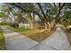 A split sidewalk leads to the fenced-in property, with trees nearby at 101 Ludlow Dr, Longwood, FL 32779