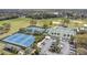 Aerial view of the community's athletic and recreational facilities featuring tennis courts, baseball fields, and a parking area at 102 Spanish Moss Ct, Orlando, FL 32828