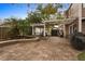 Paver backyard featuring a pergola, custom landscaping with palm trees, and outdoor kitchen area, perfect for entertaining at 102 Spanish Moss Ct, Orlando, FL 32828