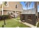 Lush backyard featuring a playhouse, swing set, and well-maintained artificial turf for outdoor play at 102 Spanish Moss Ct, Orlando, FL 32828