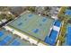 Aerial view of community basketball courts with blue and green playing surface in sunny residential neighborhood at 102 Spanish Moss Ct, Orlando, FL 32828