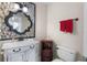 Stylish bathroom featuring a modern vanity, decorative mirror, and neutral color palette at 102 Spanish Moss Ct, Orlando, FL 32828