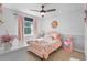 Charming bedroom with a full bed, soft pink accents, and natural light at 102 Spanish Moss Ct, Orlando, FL 32828