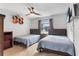 Neutral bedroom featuring two twin beds, modern ceiling fan, and wall-mounted TV at 102 Spanish Moss Ct, Orlando, FL 32828