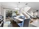 Bright dining area with a wooden table, bench, and access to an outdoor patio with seating at 102 Spanish Moss Ct, Orlando, FL 32828