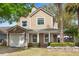 Charming two-story home with manicured shrubs, an attached garage, and a welcoming front porch at 102 Spanish Moss Ct, Orlando, FL 32828