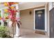 Cozy front porch features a dark door, lovely plants, and a charming welcome mat at 102 Spanish Moss Ct, Orlando, FL 32828