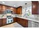 Well-equipped kitchen features stainless steel appliances and beautiful countertops at 102 Spanish Moss Ct, Orlando, FL 32828