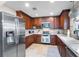 Kitchen showcasing stainless steel appliances, granite countertops, and dark wood cabinetry at 102 Spanish Moss Ct, Orlando, FL 32828