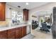 Open kitchen with stainless steel dishwasher and appliances flowing to the dining area at 102 Spanish Moss Ct, Orlando, FL 32828