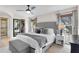 Bright main bedroom with a large bed, walk-in closet, and ensuite bathroom at 102 Spanish Moss Ct, Orlando, FL 32828