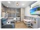 Creative playroom featuring decorative wood accent wall, workstation, television, and play kitchen at 102 Spanish Moss Ct, Orlando, FL 32828