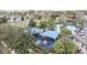 Aerial view of covered playground with slides, climbing toys, and soft padded ground surrounded by trees at 102 Spanish Moss Ct, Orlando, FL 32828