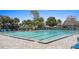 Community swimming pool with lounge chairs and umbrellas on a sunny day at 102 Spanish Moss Ct, Orlando, FL 32828