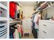 Organized walk-in closet with hanging racks, shelving, and a small chair for convenience at 102 Spanish Moss Ct, Orlando, FL 32828