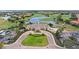 Aerial view showcases community clubhouse, golf course, pond, and surrounding homes at 10236 Beechwood Ln, Orlando, FL 32832