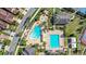 Aerial view highlighting a community pool with a splash pad, regular pool, cabanas, and landscaping on a sunny day at 10236 Beechwood Ln, Orlando, FL 32832