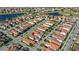 An aerial scene of a community shows neatly arranged homes with tile roofs amidst green lawns and waterways at 10236 Beechwood Ln, Orlando, FL 32832