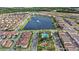 Aerial view of a residential community featuring a lake with a fountain, pool and playground at 10236 Beechwood Ln, Orlando, FL 32832