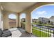 View from an arched balcony, featuring a seating area and neighborhood views at 10236 Beechwood Ln, Orlando, FL 32832