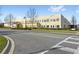 Exterior shot of a modern, light-colored commercial building with clean lines, ample windows, and well-kept landscaping at 10236 Beechwood Ln, Orlando, FL 32832