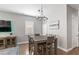 Dining area with a chandelier, rustic wood table, and seating for six at 10236 Beechwood Ln, Orlando, FL 32832