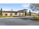 Attractive clubhouse exterior with stone accents, large arched windows, and lush landscaping along the front of the building at 10236 Beechwood Ln, Orlando, FL 32832