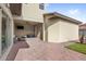 Backyard view with covered patio, brick paved area, and green space at 10236 Beechwood Ln, Orlando, FL 32832