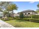 Beautiful exterior of a clubhouse building with manicured landscaping and mature palm trees against a clear blue sky at 10236 Beechwood Ln, Orlando, FL 32832