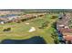 Overhead view of a meticulously maintained golf course community with scenic water features and luxury homes at 10236 Beechwood Ln, Orlando, FL 32832