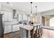 Modern kitchen with island and seating, stylish backsplash, and stainless steel appliances at 10236 Beechwood Ln, Orlando, FL 32832