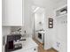 Bright laundry room featuring white cabinets, modern appliances, and a convenient mudroom area at 10236 Beechwood Ln, Orlando, FL 32832