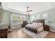 Comfortable main bedroom with natural light, wooden furniture, and a cozy area rug at 10236 Beechwood Ln, Orlando, FL 32832