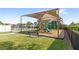 Community playground featuring modern play equipment, a shaded structure, a bench, and a safety fence in a well-maintained area at 10236 Beechwood Ln, Orlando, FL 32832